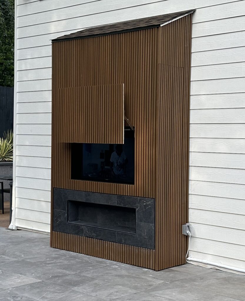 Custom Outdoor Cabinet with hidden hinges and TV and Fireplace